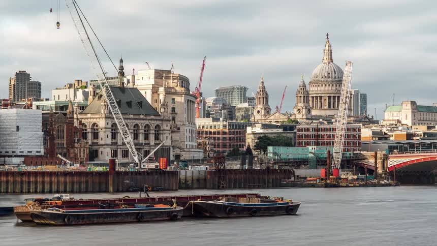 Landscape of waterfront city buildings with a port on a cloudy day