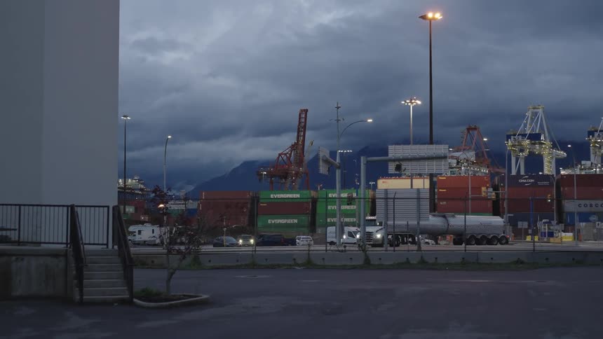 View of cars and trucks passing through a port and logistics center with containers