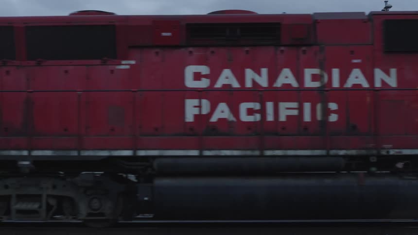 A freight train passing under the tracks in the port area