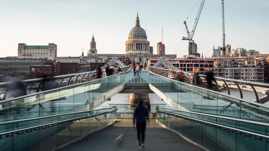 Pedestrians waling over the millennium bridge in london