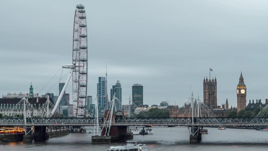 View of a bridge over the sea in a metropolis with a ferris wheel in timelapse