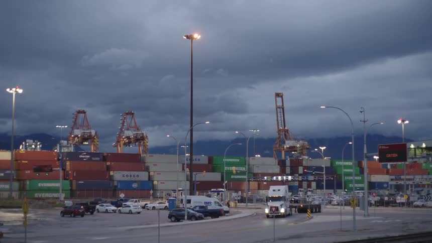 Cars drive past the storage container