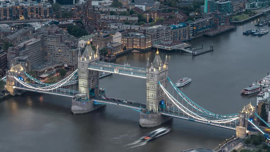 A large bridge over the water with several cars passing in timelapse on top of it