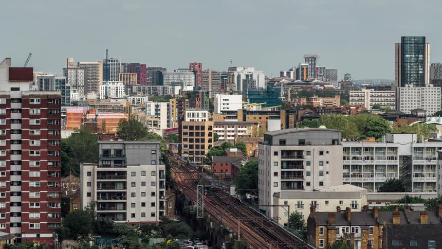 Aerial panorama of a metropolis with a central railway line in timelapse