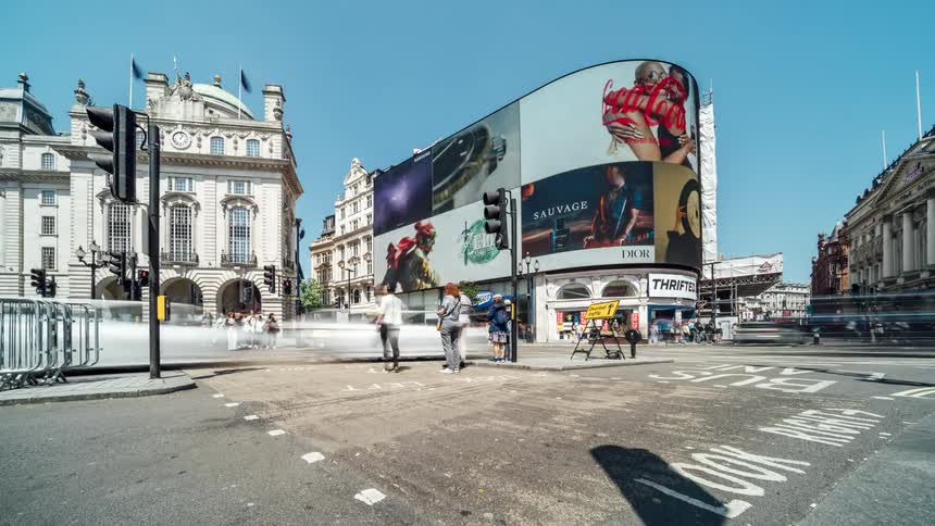 Tourists travel through the city intersection