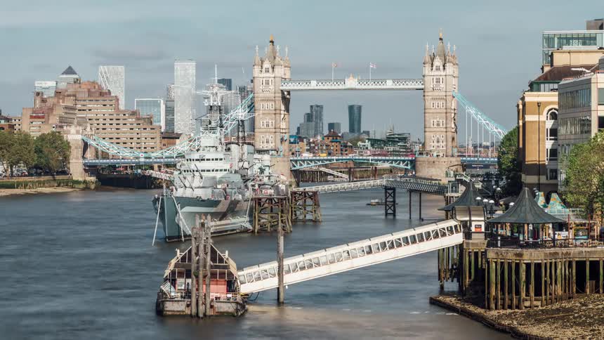 Boats in the thames move under the tower bridge