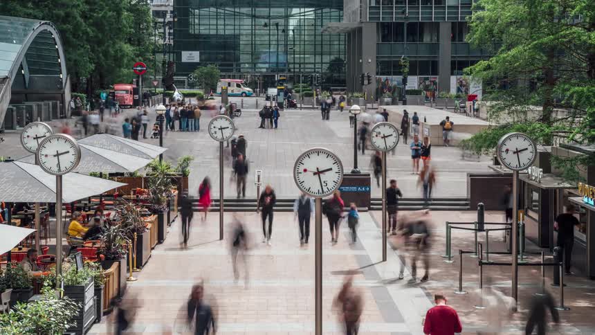 A busy street that doesnt allow cars with people going back and forth