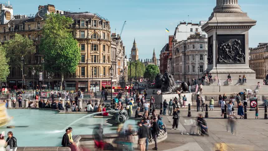 People and historic landmarks at trafalgar square on a sunny day