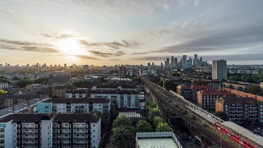 Aerial panorama of an urban metropolis next to a train line in timelapse