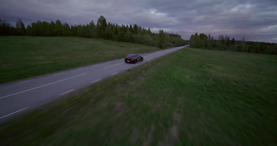A race car drives on the highway alone
