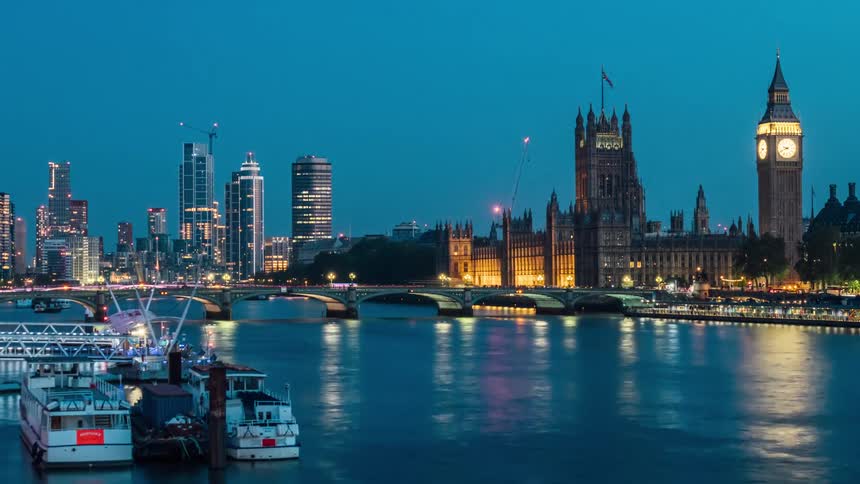 View of the sea amidst a metropolis in timelapse with the day turning into night