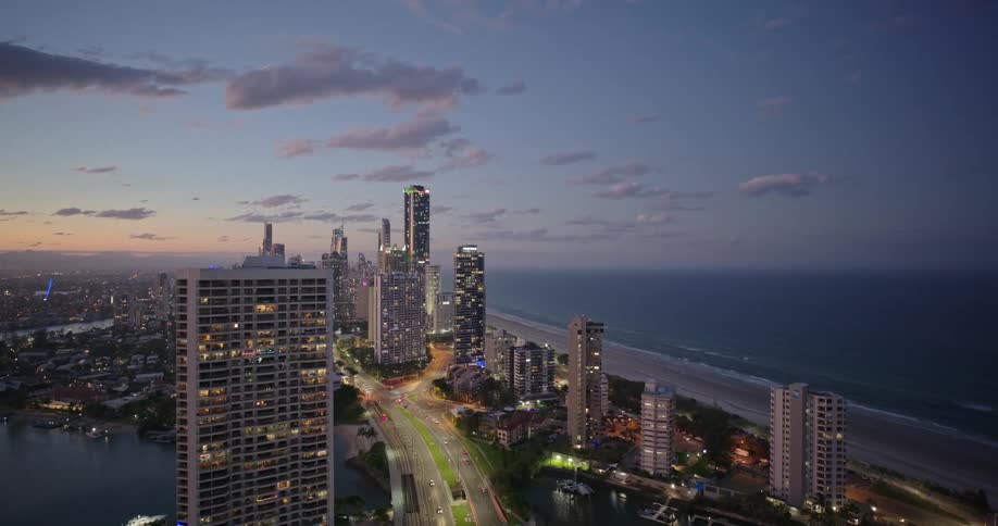 Aerial view of a modern waterfront city at sunset