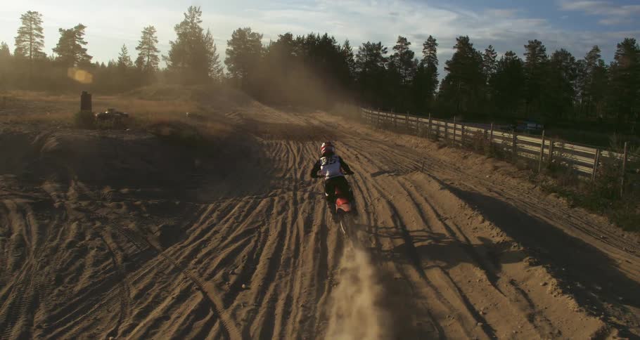 Man riding motocross on an outdoor track on a day