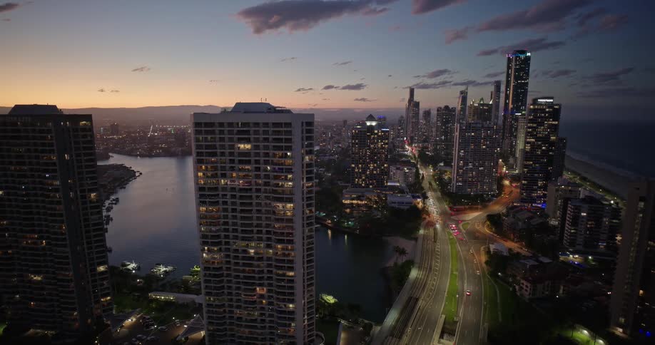 Aerial view of a modern waterfront city at sunset