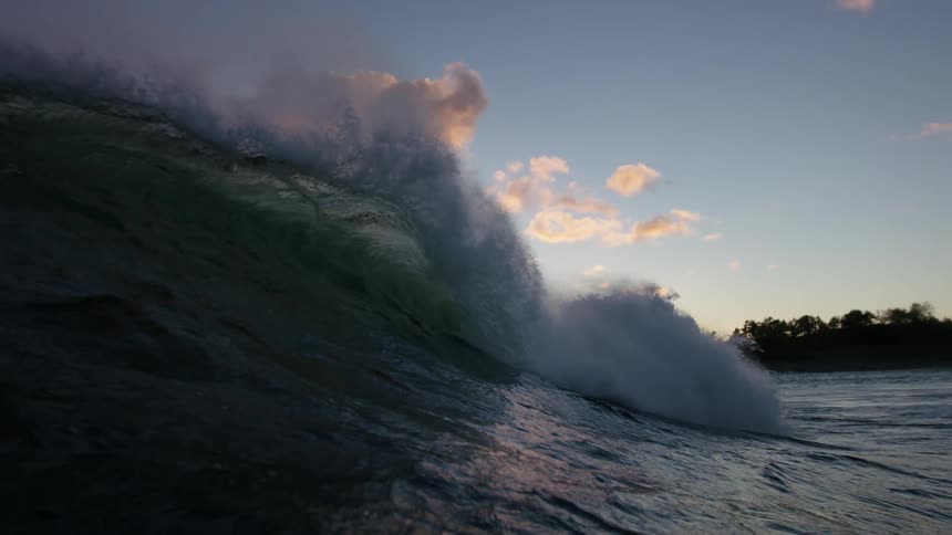 A large wave crashes in the ocean