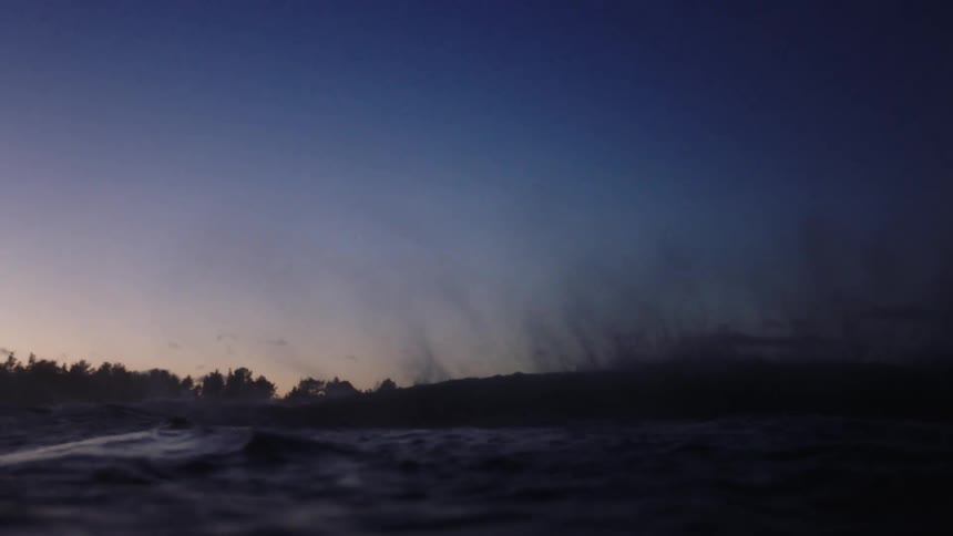 Wind blows over the waves at evening