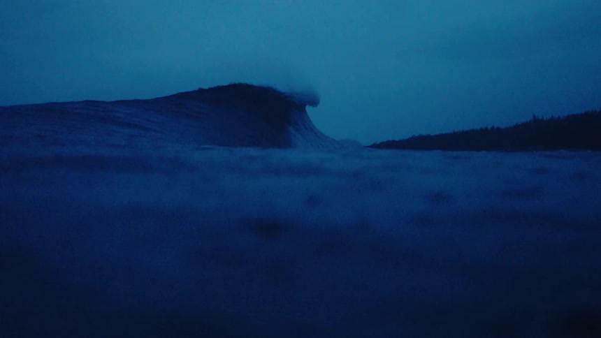 View from inside the sea of a wave breaking in slow motion