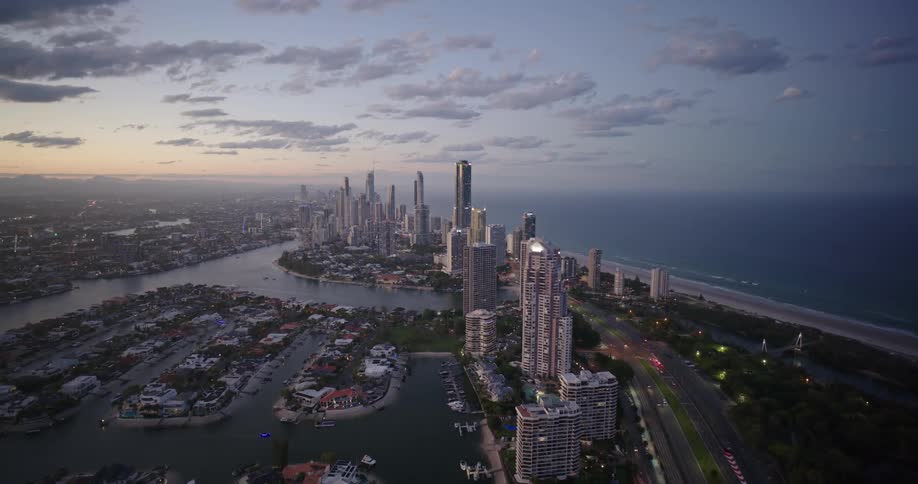 Aerial view of a modern waterfront city at sunset
