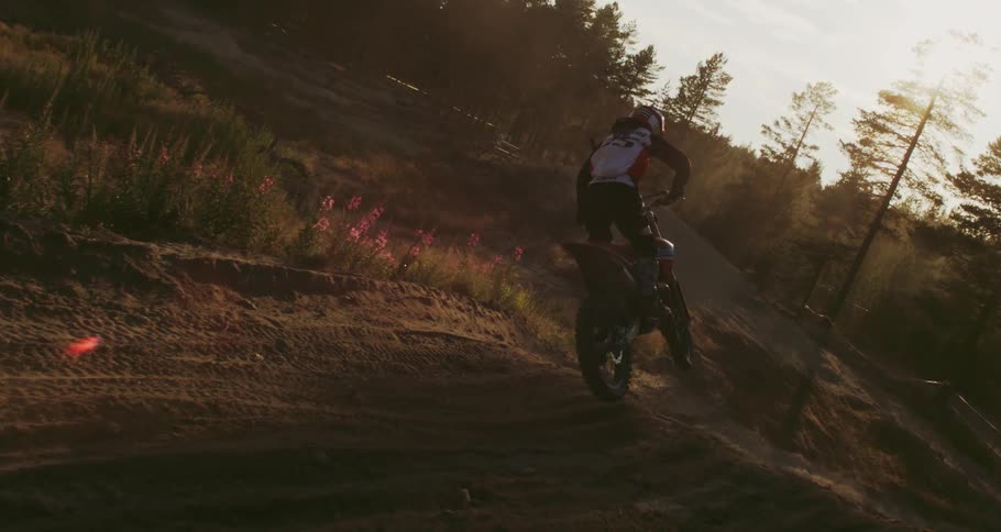 Person jumping a small motocross hill