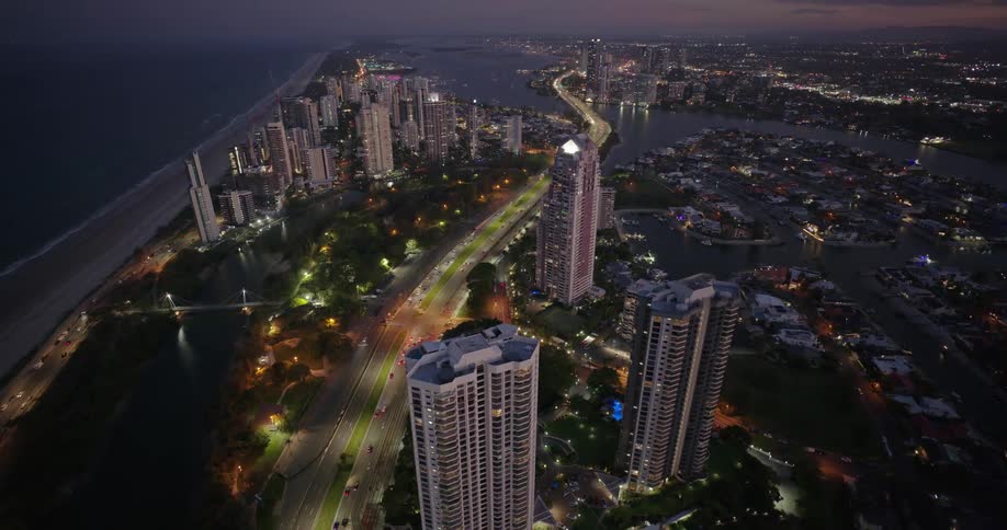 An aerial view of a lit and busy highway in a city at night