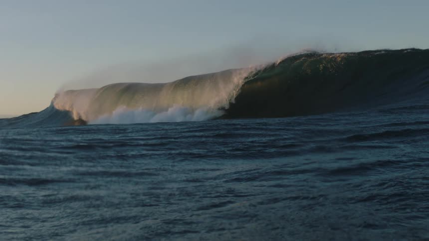 A large wave curling up as it heads forward