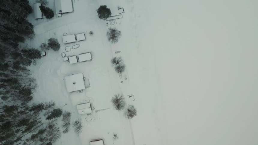 Aerial view of houses in a frozen landscape seen from above