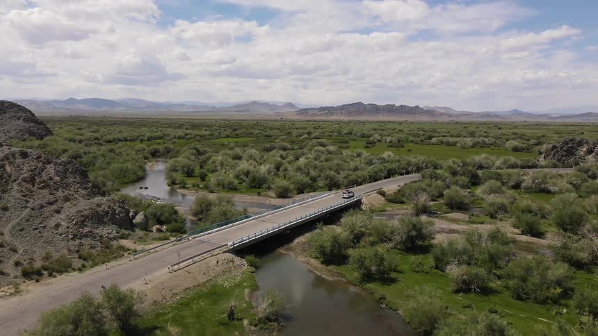 A car driving by a bridge in a freeway