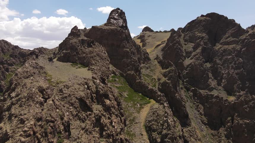 Aerial view of jagged rocky highland cliffs during the day
