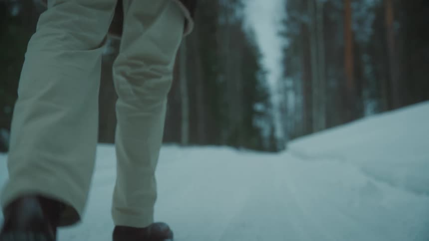 A lonely man walking in the snowcovered forest