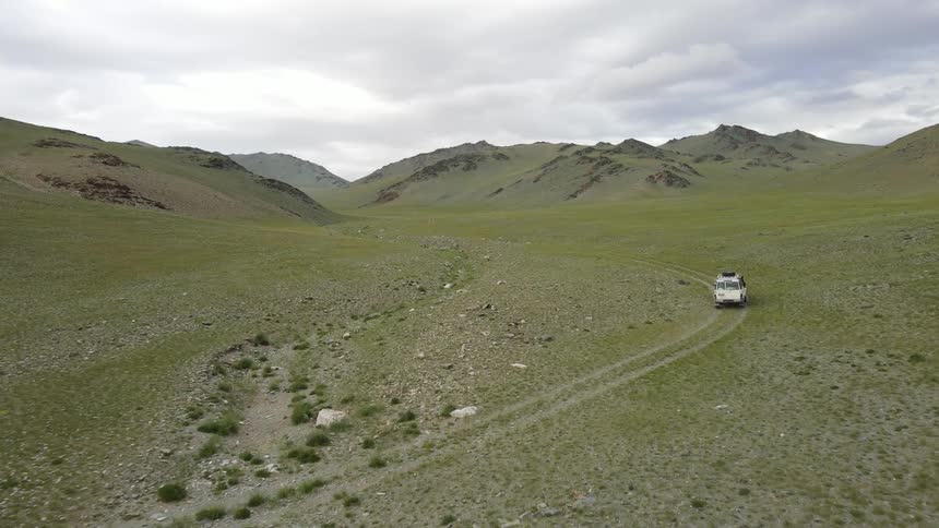 A clip of a white camping truck heading up the hill