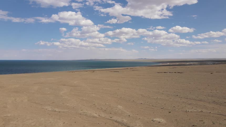 Panorama of dry ground around a blue sea