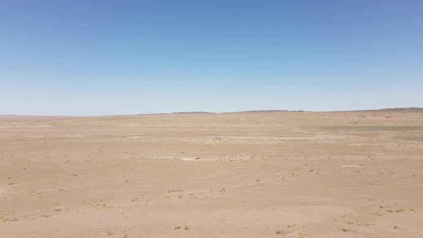 Aerial view of cars parked in the middle of the desert