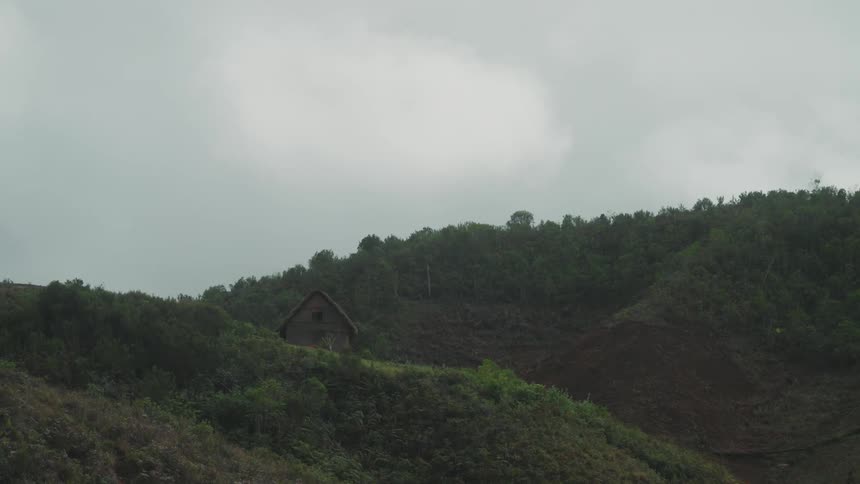 A cabin sits on the mountains