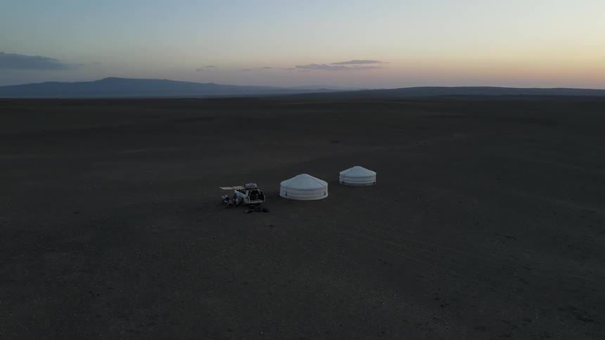 A car and two tents in a desert region