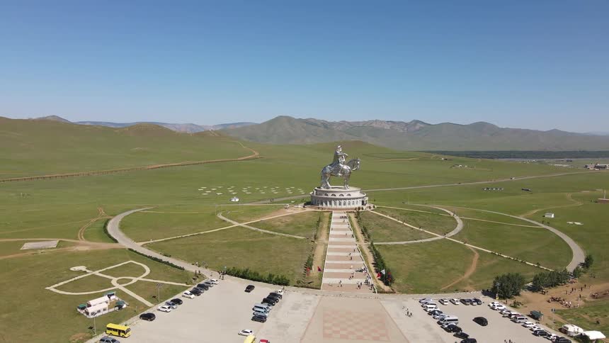 Numerous people drive to a remote landmark with a huge sculpture on it