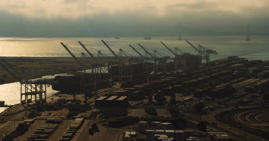 Cranes on a shipping port at sunset, the Port of Oakland on the San Francisco Bay