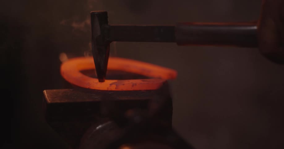 A red hot steel is being forged