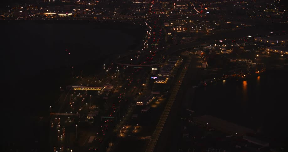 Helicopter aerial at night with lights shinning all through the city, Oakland CA