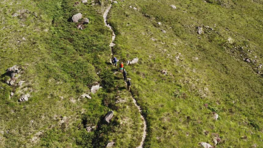 An aerial clip of people going on a hiking