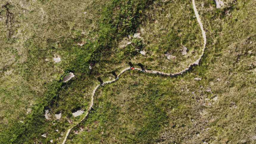 A small group of people hiking on a trail
