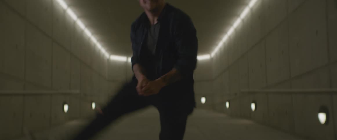 Man in a white corridor dances,