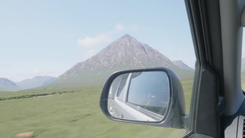 Mountain peak seen from the window of a moving car