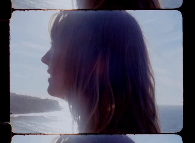 Closeup of a womans face admiring the beach on a sunny day