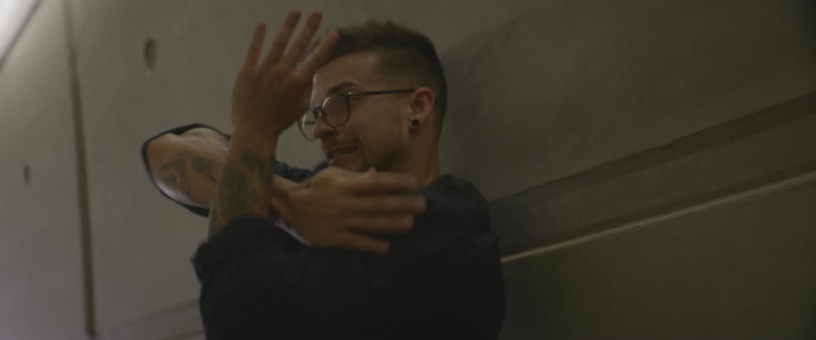 Dancing man waves his arms in front of his face