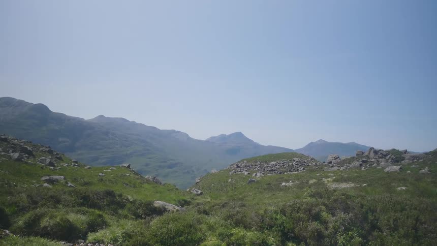 Rocks on the slopes of a mountain under a blue sky