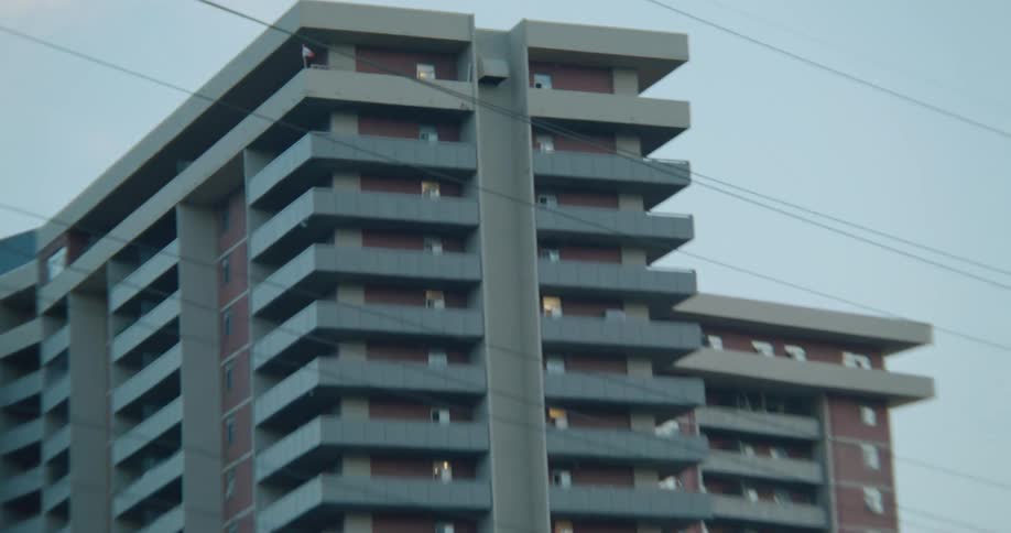 A zoom of a tall apartment building