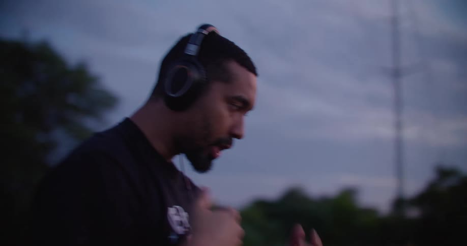 Man with headphones singing and gesturing with his hands