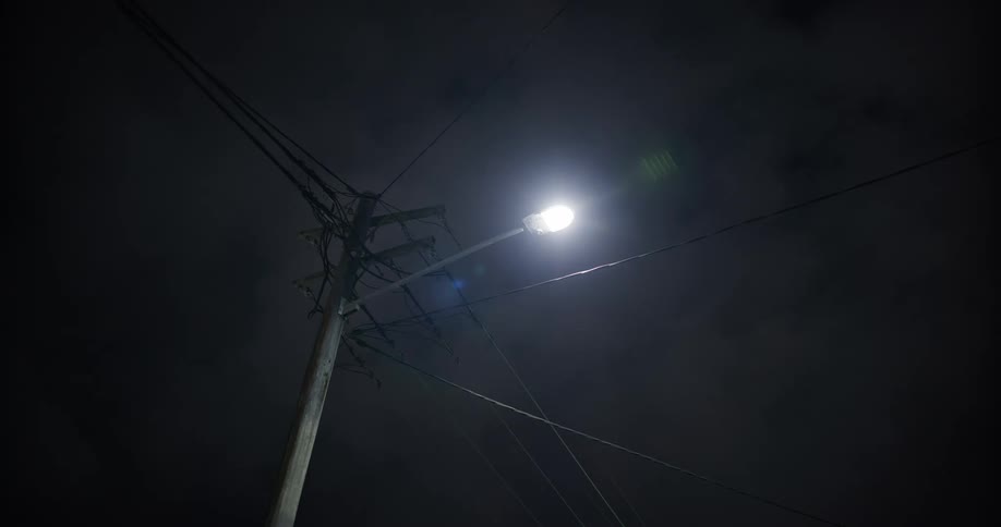 The lamp post is on at night