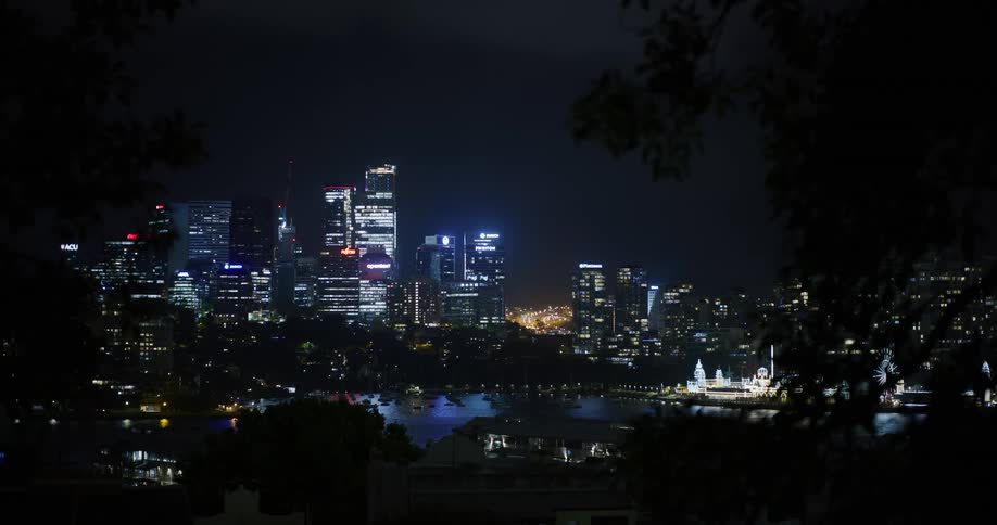A city skyline view at night with light shinning of skyscrapers