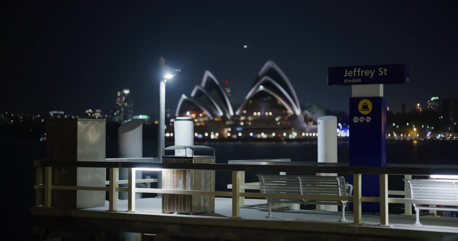 Wooden benches on the city pier at night